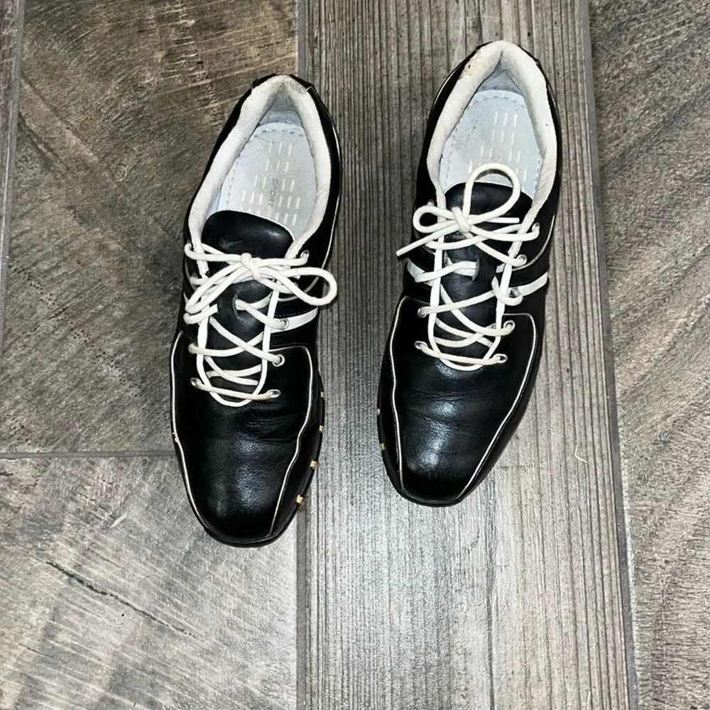 Nike Air TAC black leather golf shoes, sports performance.